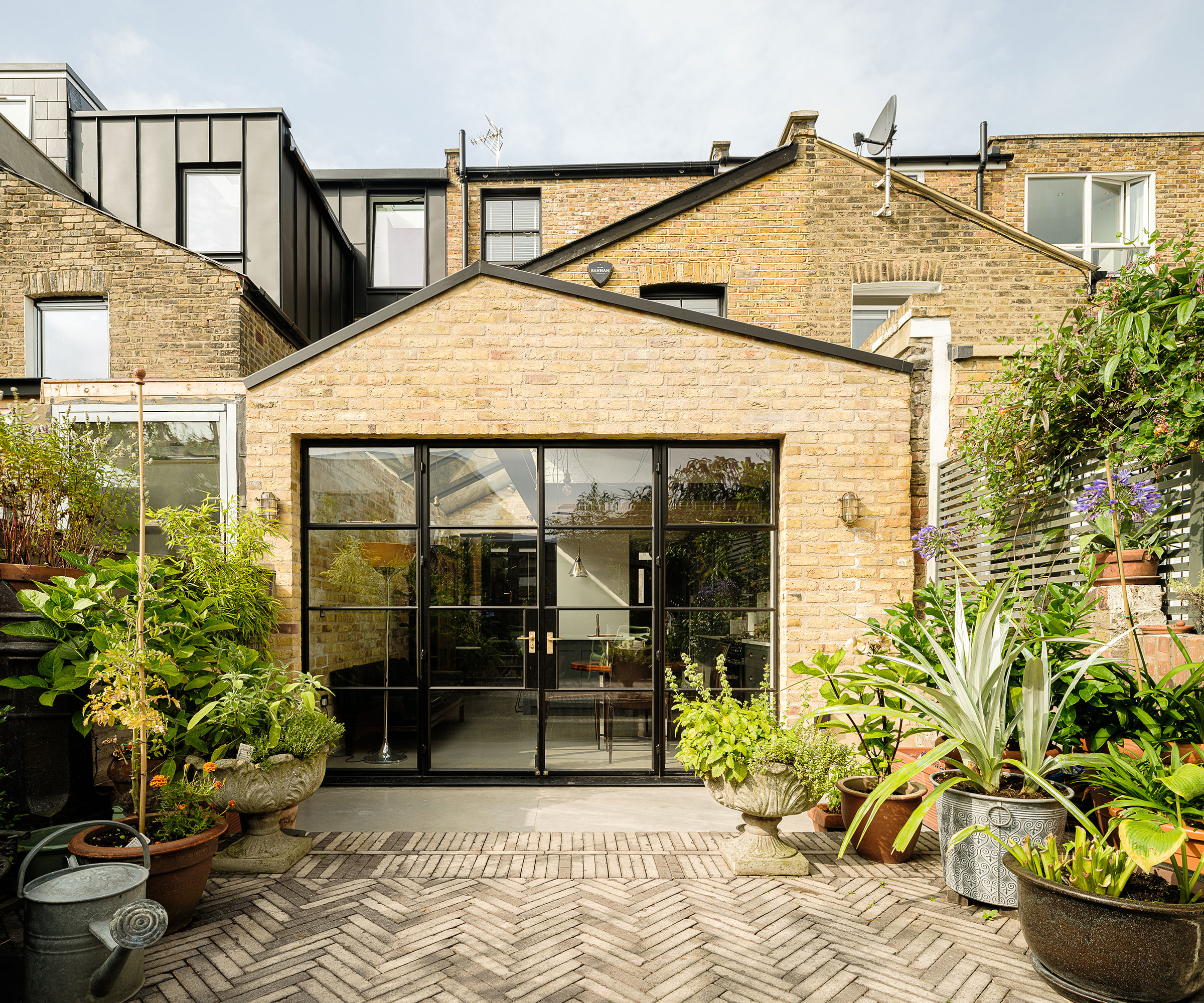 pitched roof single storey extension to terraced house with Crittall doors