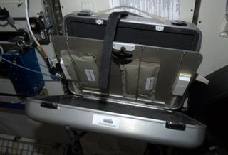 an oven on the international space station resembling a suitcase