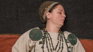 A woman wearing Bronze Age jewelry.