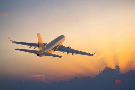 Plane in sky during sunset