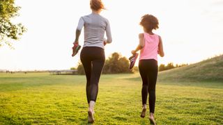 Woman and girl jogging barefoot outside
