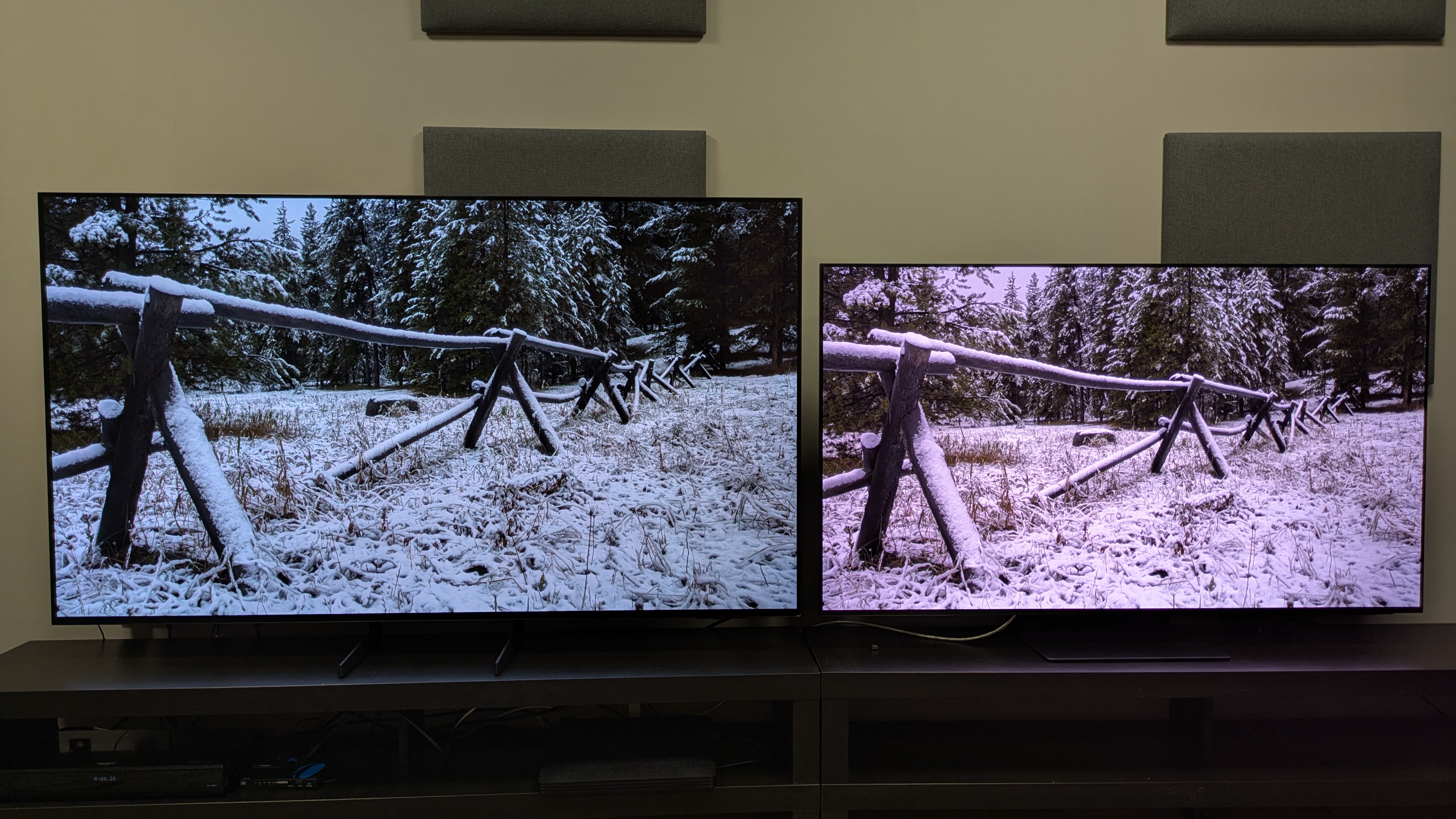 Samsung S85F (left) vs Samsung S95F (right) with snow-covered fence on screen