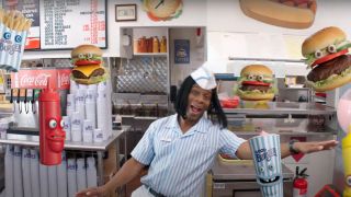 Kel Mitchell dancing around with a bunch of fast food with faces in Good Burger 2.