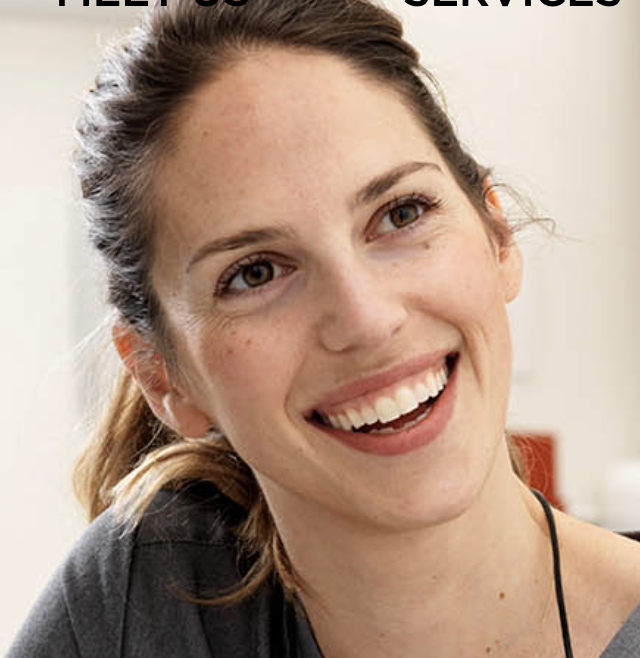 a white woman with a brunette ponytail in a gray t-shirt