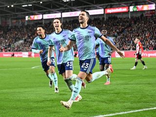 Mikel Merino celebrates scoring the 2nd Arsenal goal with (L) Ethan Nwaneri and (2ndL) Riccardo Calafiori during the Premier League match between Brentford FC and Arsenal FC at Brentford Community Stadium on January 01, 2025 in Brentford, England. 