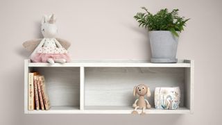 White wall shelf from Mamas & Papas against a pink wall