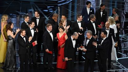 HOLLYWOOD, CA - FEBRUARY 26:(L-R) 'La La Land' producer Jordan Horowitz holds up the winner card reading actual Best Picture winner 'Moonlight' with actor Warren Beatty and host Jimmy Kimmel 