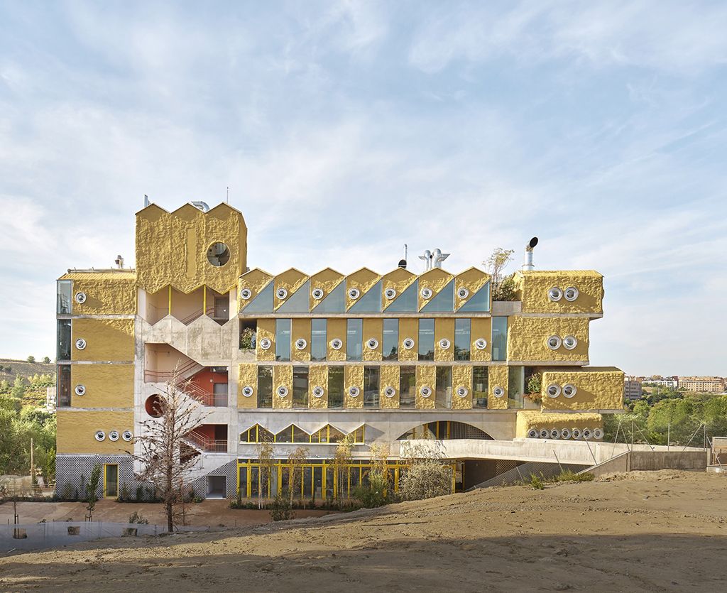 reggio school, a colourful building against blue skies