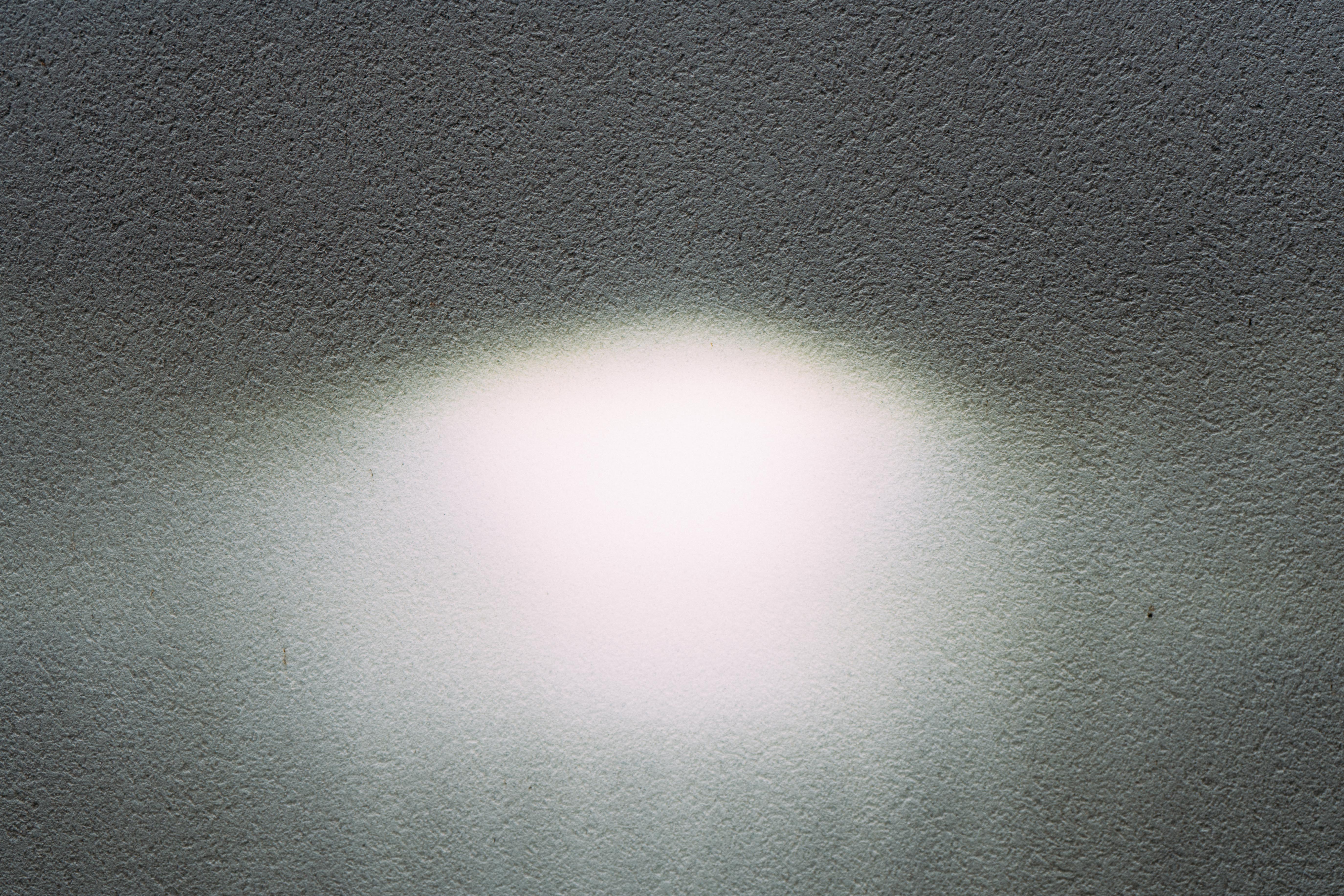 a pattern of light on a white wall