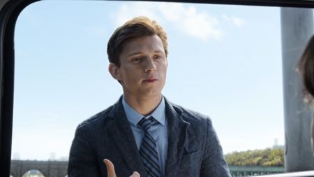 Peter in his wrinkly suit through a car window in Spider-Man: No Way Home.