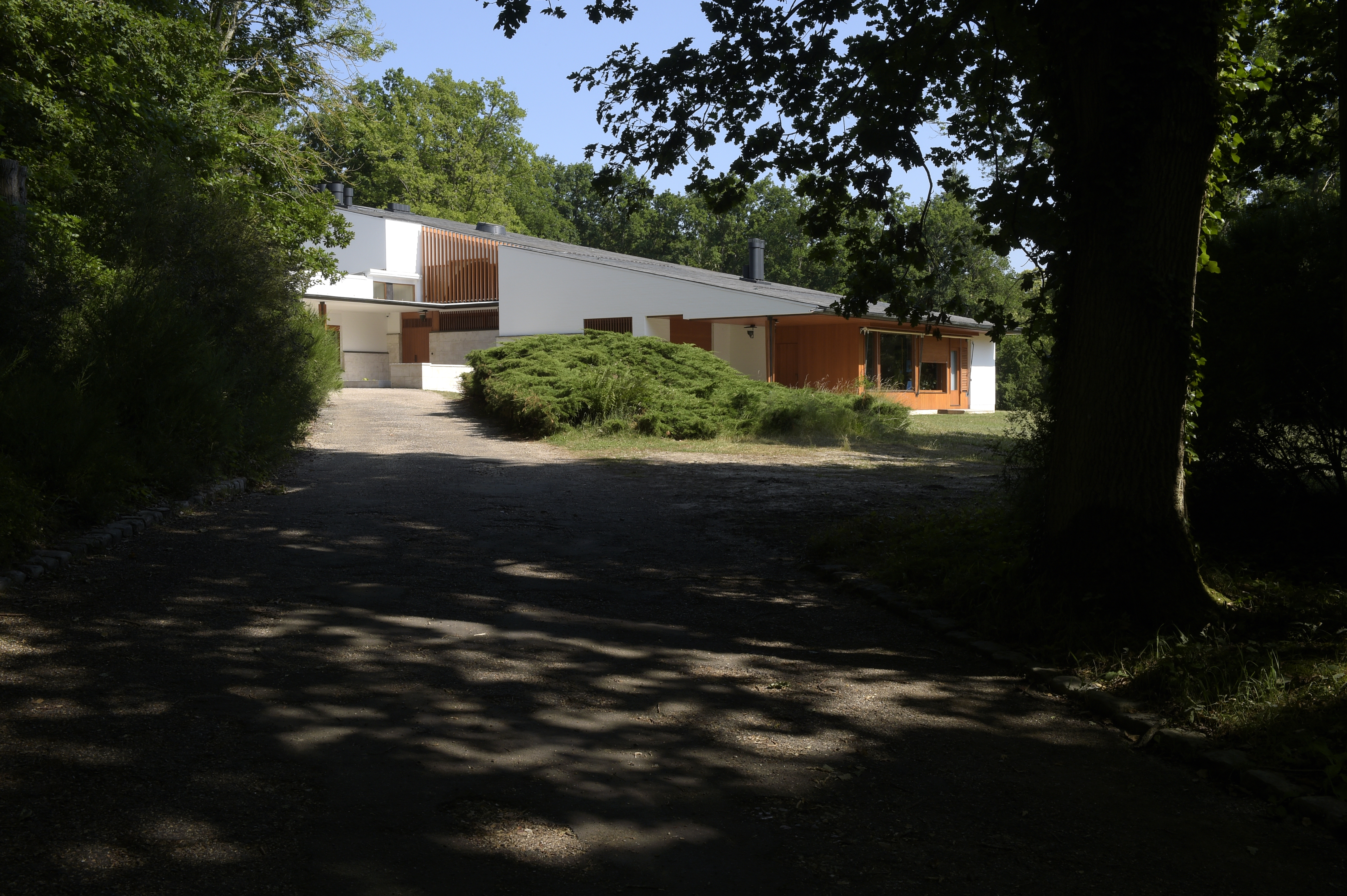 the white, clear, crisp and restored Maison Louis Carre by Alvar Aalto against blue skies