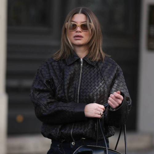 BERLIN, GERMANY - APRIL 01: Sophia Geiss seen wearing a woven-texture Second Female jacket paired with dark Uniqlo wide-leg jeans with turned-up hems, styled with a structured DeMellier bag, and P.J. Lobster sunglasses, with mid-length hair worn loose in soft, natural waves and a subtle center part on April 01, 2026 in Berlin, Germany. (Photo by Jeremy Moeller/Getty Images)