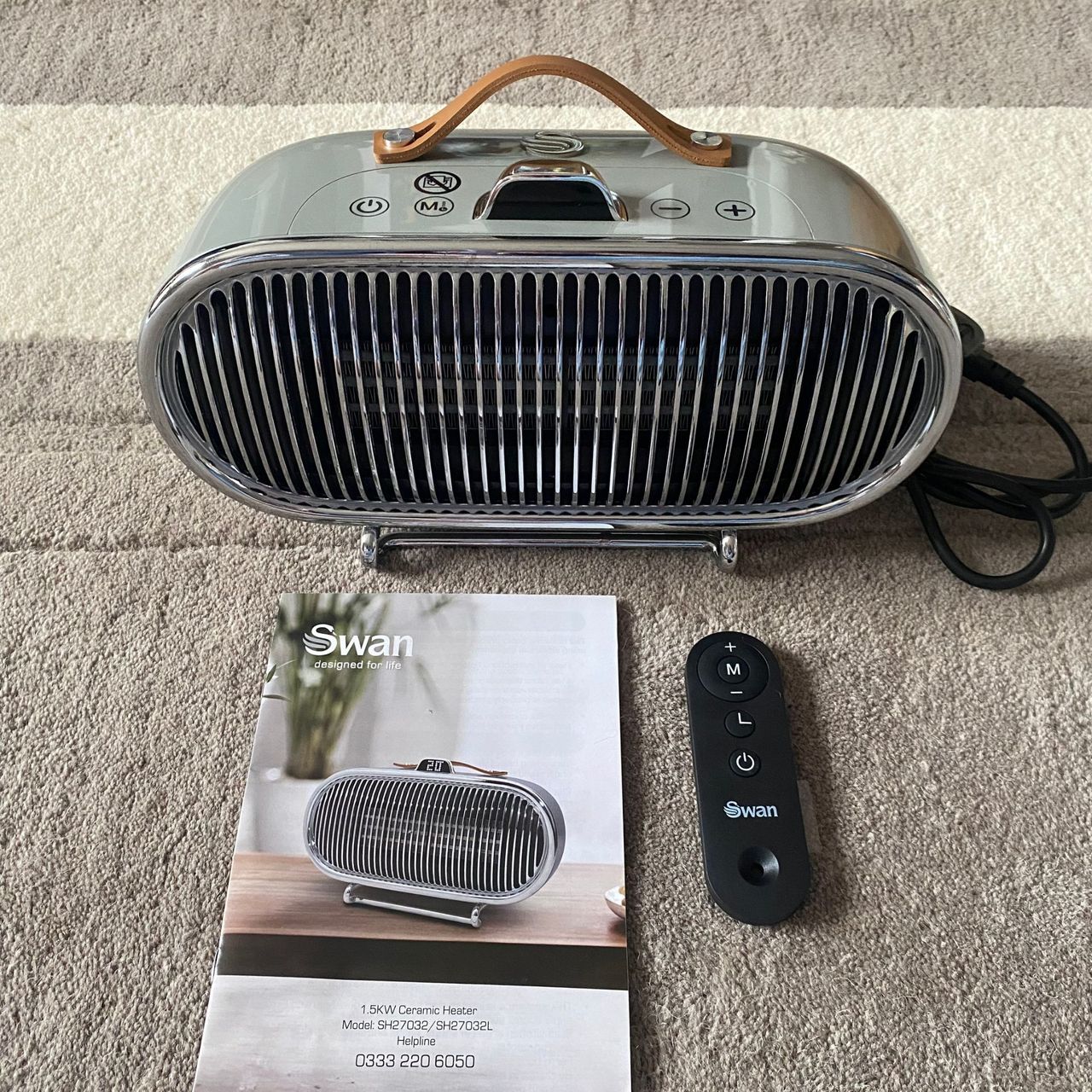 Swan 1.5kW Retro Ceramic Heater, the remote and instruction manual arranged on a grey and cream rug