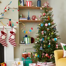 A brightly decorated Christmas tree in a decorated living room