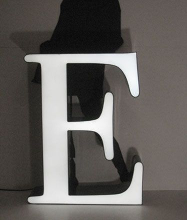 Letter E LED sign in front of a person in silhouette