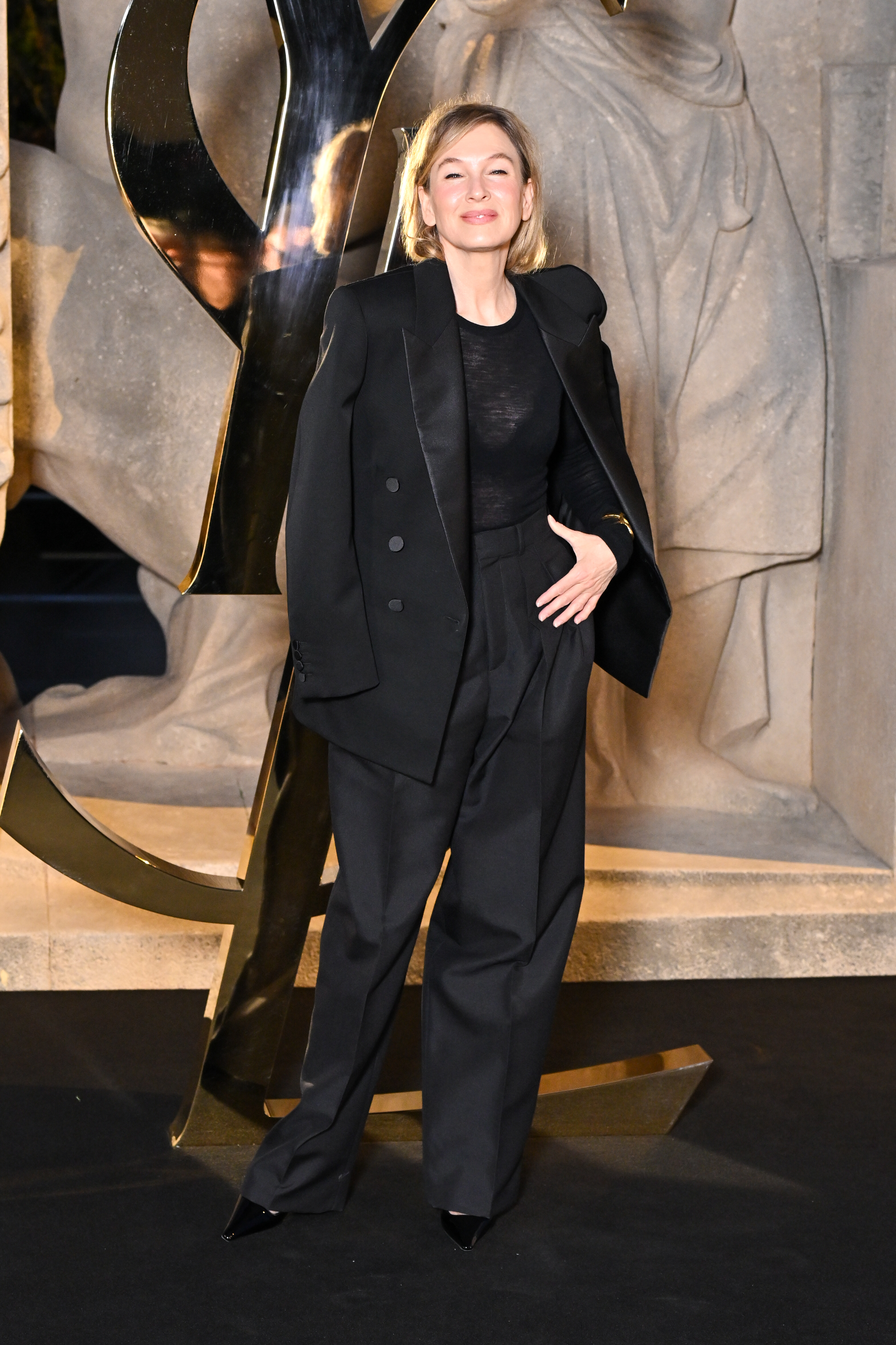 renee zellweger wearing a black coat and trousers at saint laurent