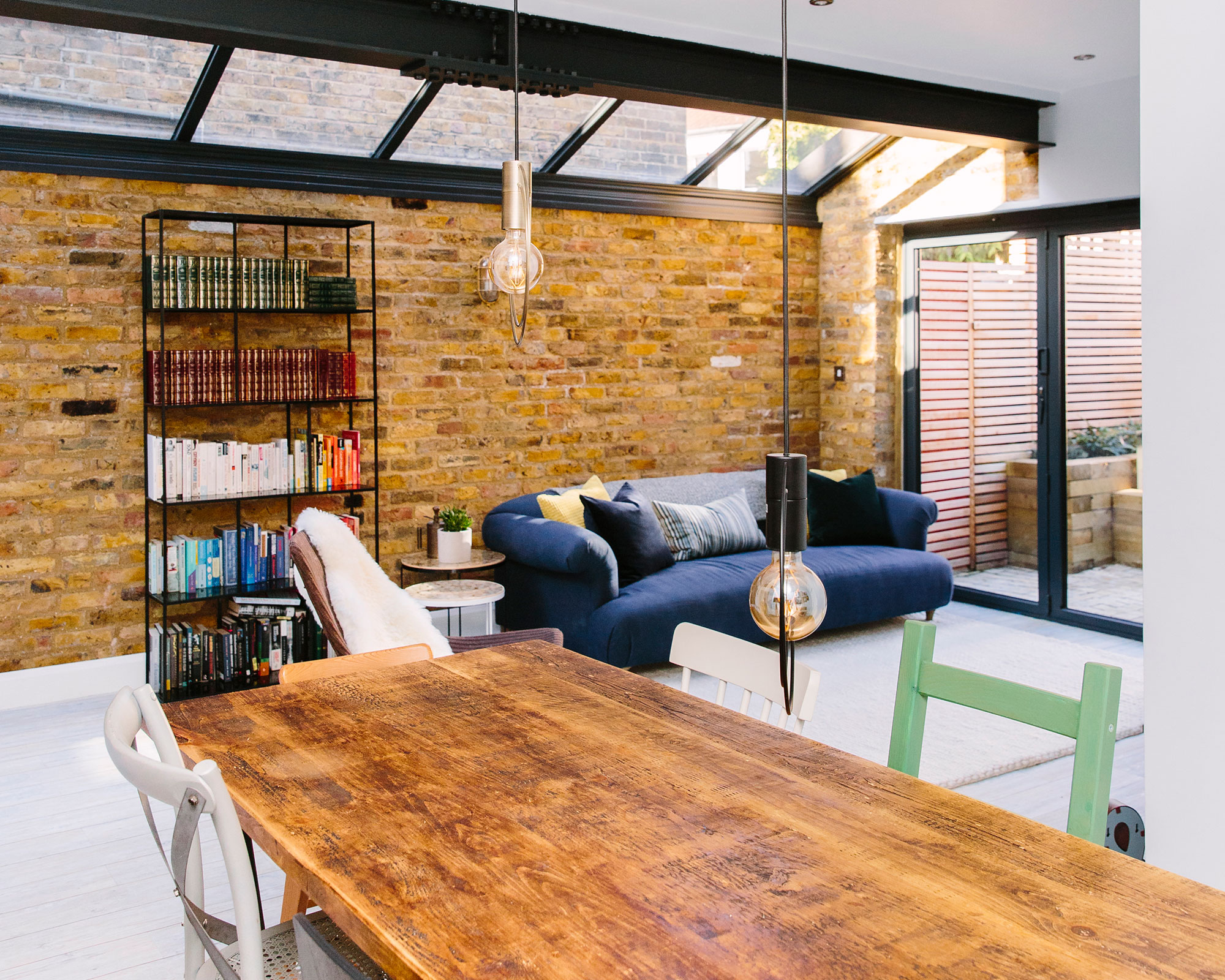 dining space with brick walls and wooden dining set