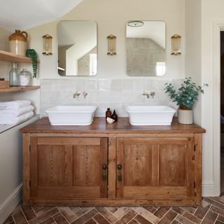 bathroom with a large traditional twin basin vanity unit, mirror, open shelving, and terracotta floor tiles