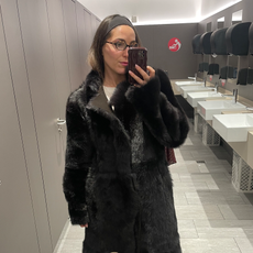 senior fashion editor Anna LaPlaca wearing a faux fur coat at the airport