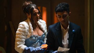 Nugget and Priya clean the basement while wearing their wedding outfits