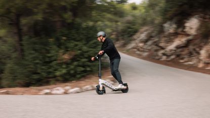 Best electric scooter: Pictured here, Lando Norris thundering down the hill on a Pure e-scooter
