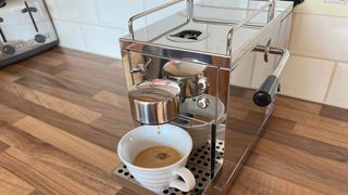 The Grind One Pod machine being used to brew an espresso