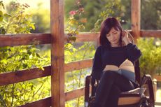 A girl reading a good book.