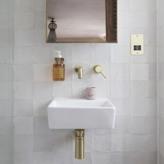 Downstairs cloakroom with white textured tiles