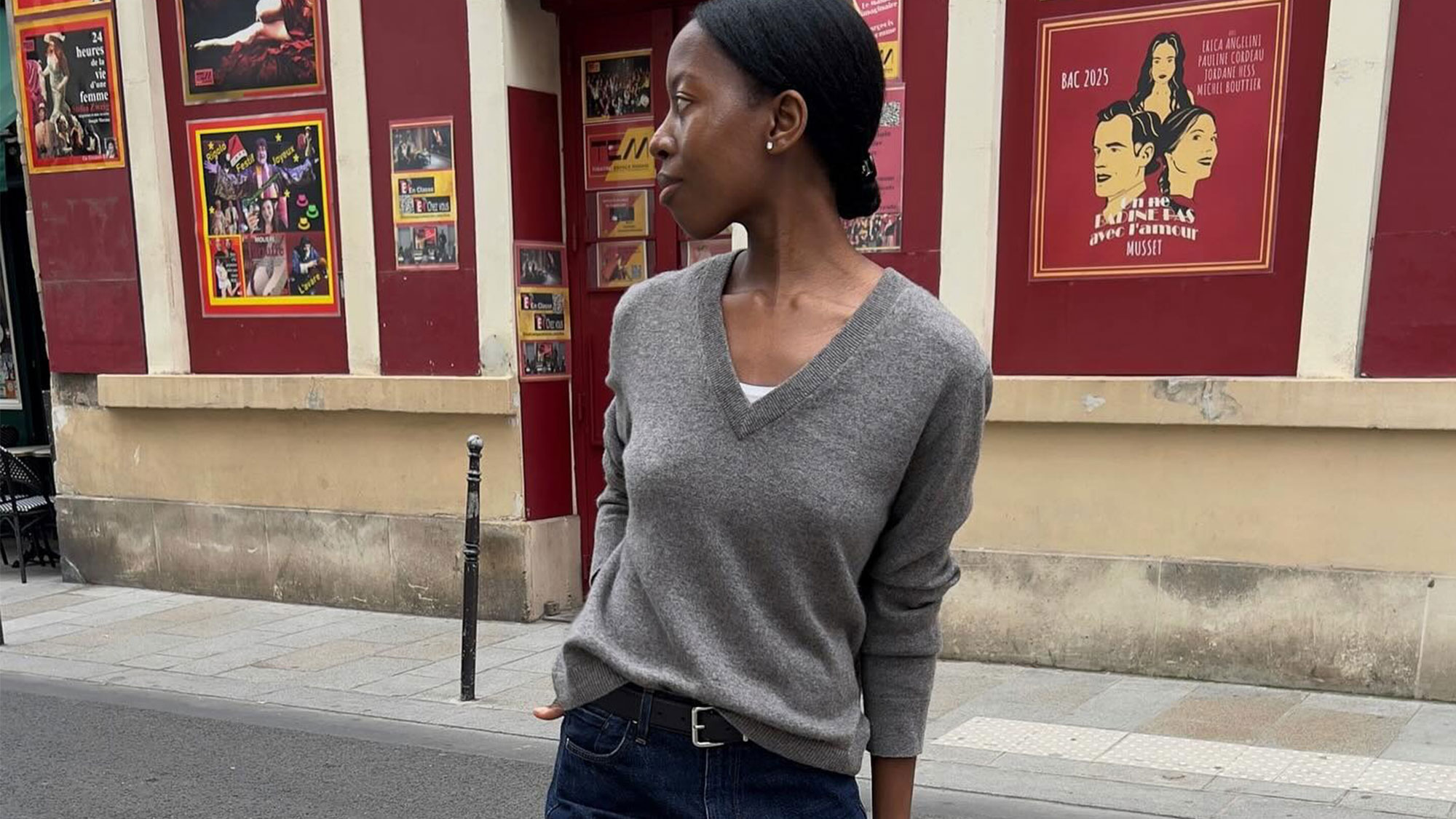 A french woman in a sweater and jeans