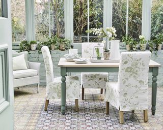 Pastel green dining table decor in conservatory by Neptune