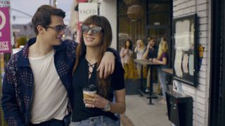 Nicholas Galitzine and Anne Hathaway walking arm in arm in The Idea of You