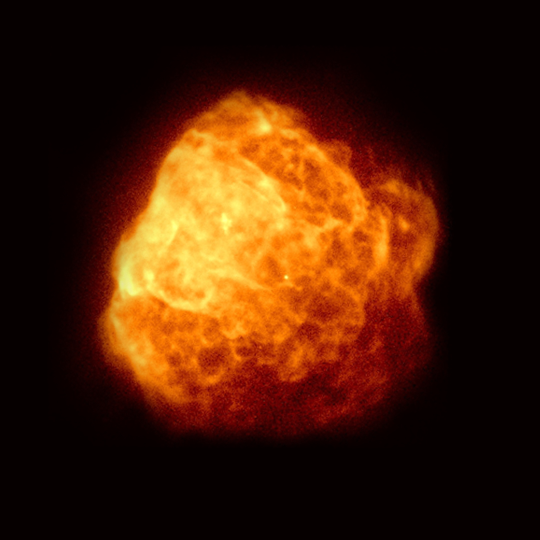 View of a slightly blurry yellow and orange cloud in space.