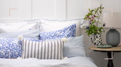White bedroom with white and blue bedding to suggest how to keep a bedroom cool in summer