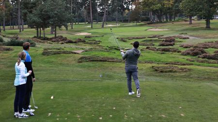 A golfer hitting a tee shot