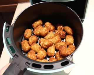 Cooked tater tots in the Dash 2-quart air fryer