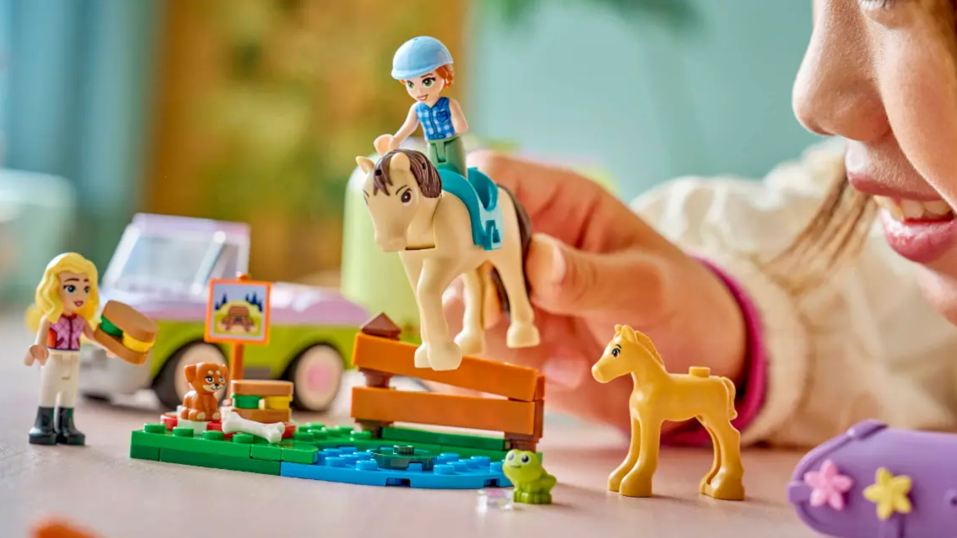 A child plays with a Lego horse set