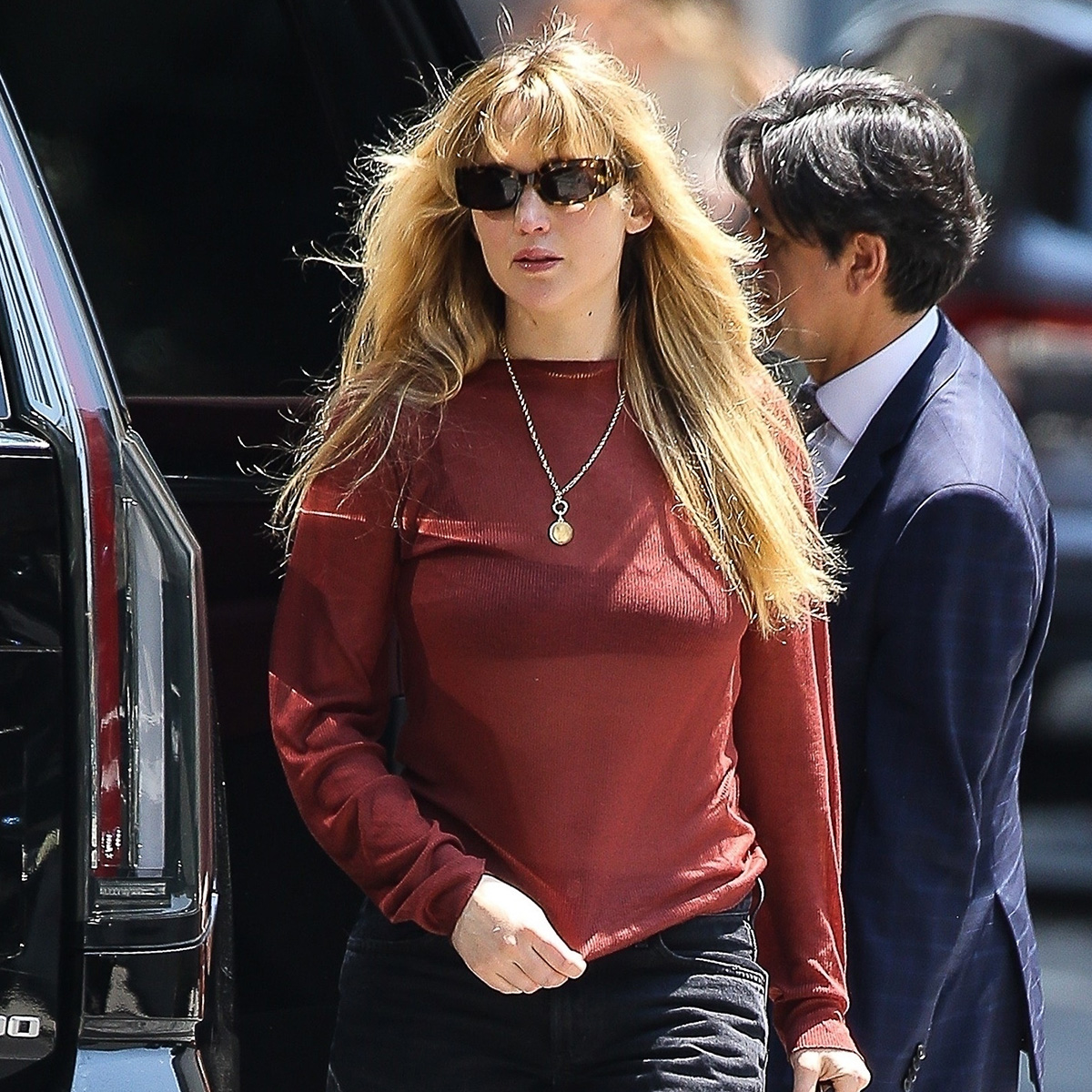 J.Law wears a red top with black jeans.