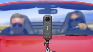 Insta360 X4 360 degree camera mounted to a red convertible car's bonnet