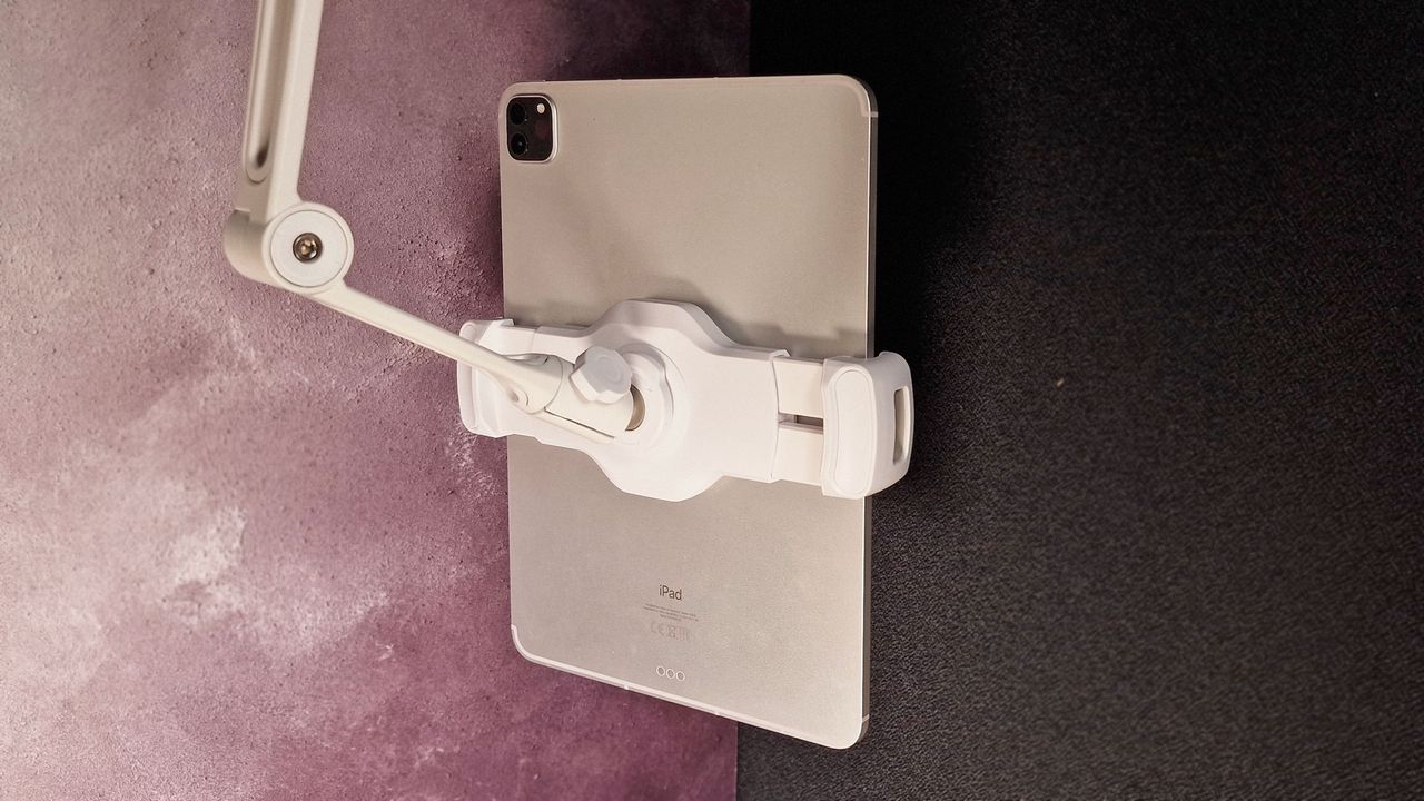 A photo of the HoverBar Duo stand with an iPad in it against a dark background