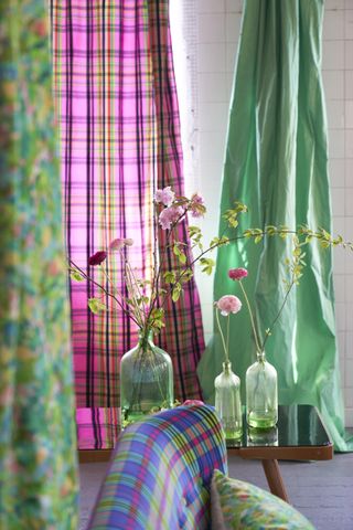 Green, blues and purples on sofa, cushion and curtains