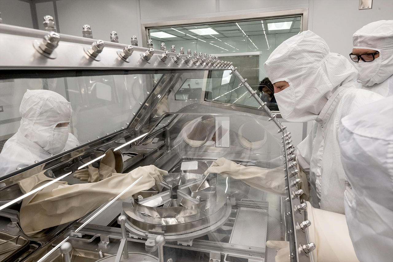 NASA's OSIRIS-REx curation team rehearse the opening of the asteroid sample canister in the newly built OSIRIS-REx Curation lab at Johnson Space Center.