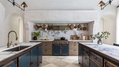 modern rustic kitchen with marble backsplash and dark blue cabinets