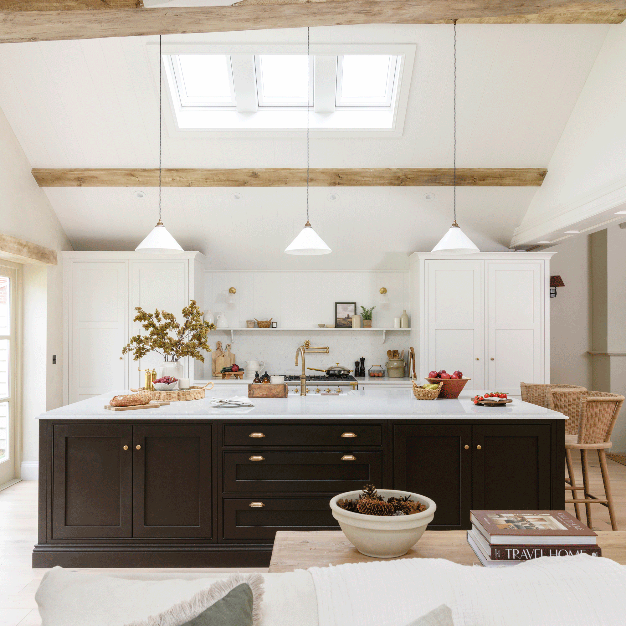 a large neutral open plan kitchen living area with Shaker kitchen cabinets and a large black kitchen island with storage