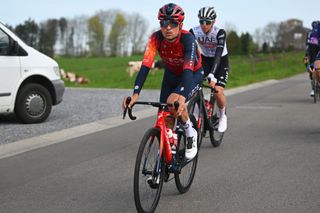 Tom Pidcock at Flèche Wallonne, with the eventual winner in the background