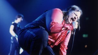 Meat Loaf screams into the microphone during a live concert