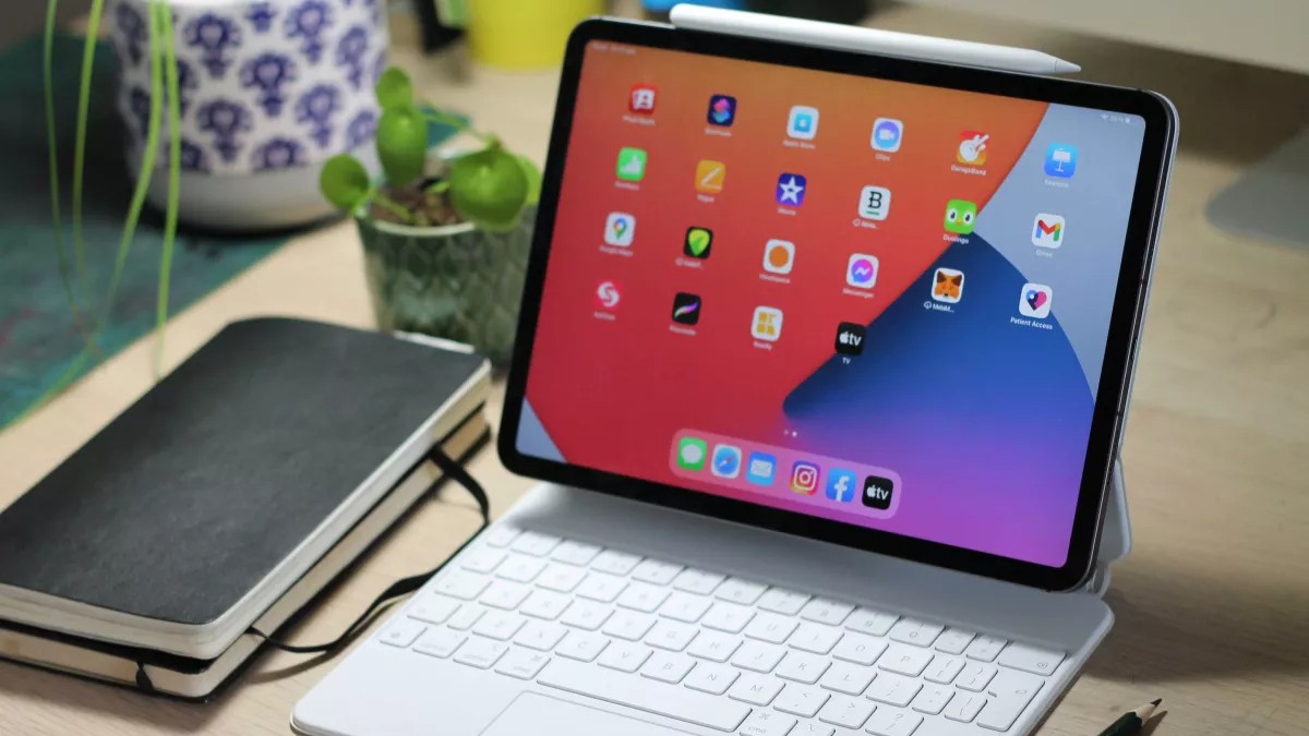 Apple vs Samsung; iPad Pro 11-inch paired with a Magic Keyboard on a cluttered desk