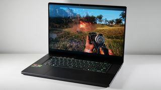 The Asus ROG Zephyrus G16 (Ryzen AI 9) open on a white table with Far Cry 6 on screen.