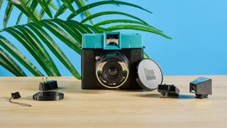 A black and teal Lomography Diana Instant Square instant camera