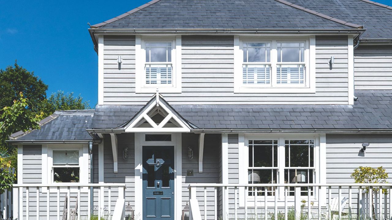 A wooden house with a blue front door 