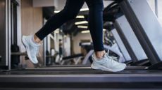 Lower view of woman's legs on treadmill at the gym doing treadmill workouts